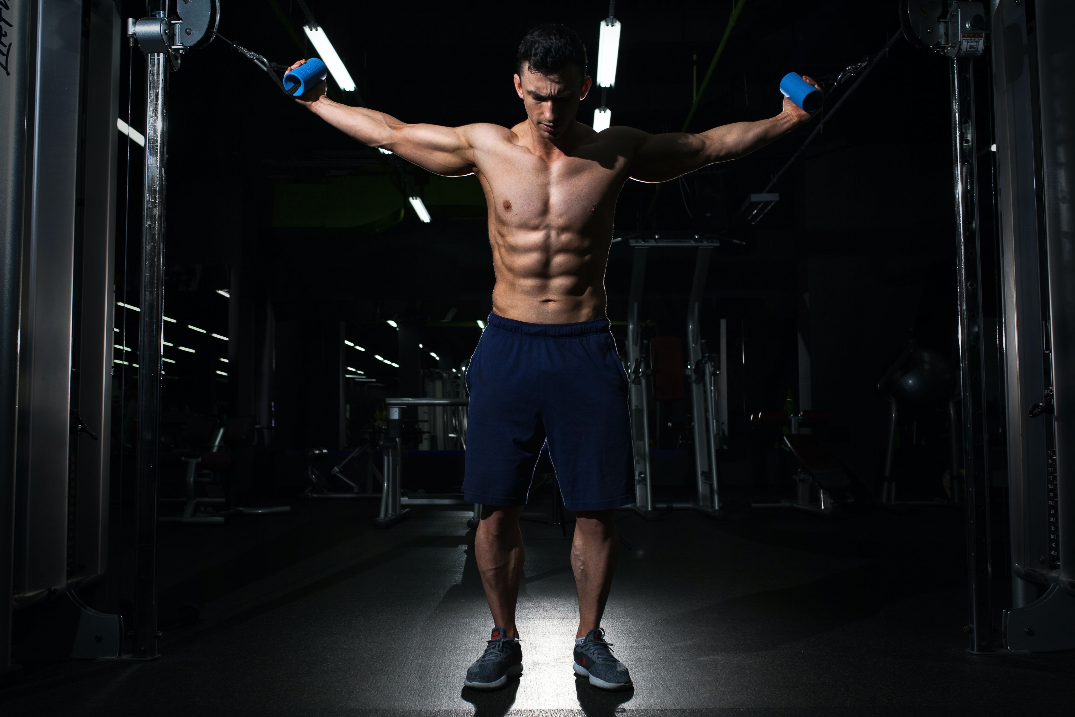 man exercising inside dim room